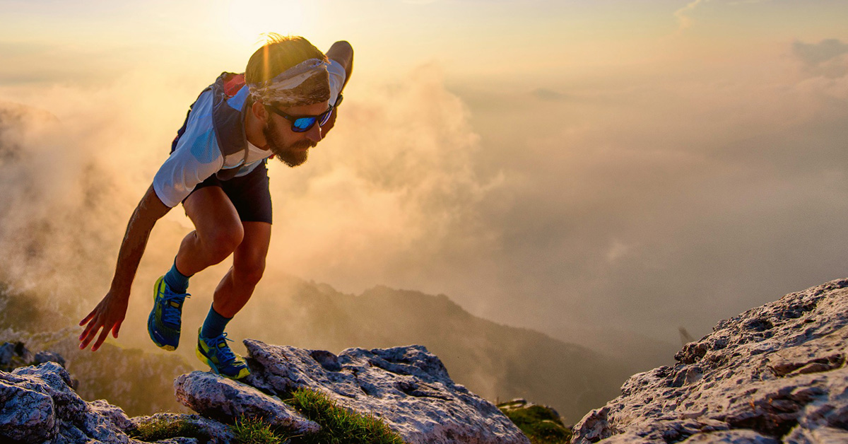 A runner summits a mountain