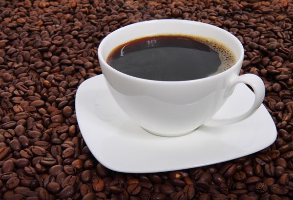Cup of coffee on a background of coffee beans.