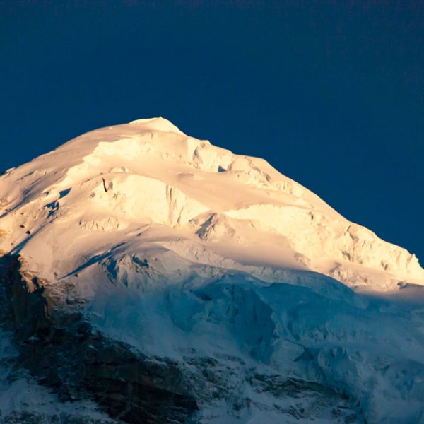 Snow-capped mountain against a blue sky